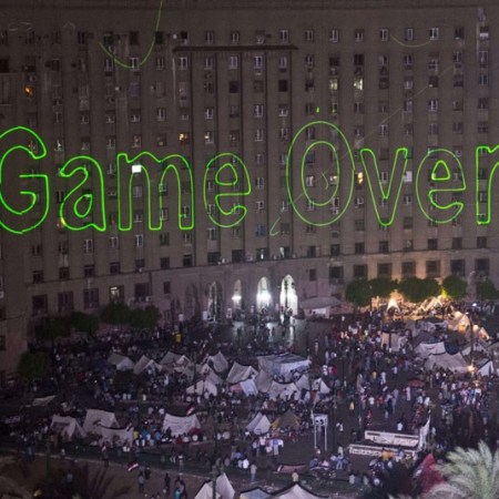 Egyptians declaring the start of the end of all radical Islamism during their 30th of June revolution. Protesters show a large "Game over" sign on the Tahrir square building in Cairo, Egypt 30-6-2013.