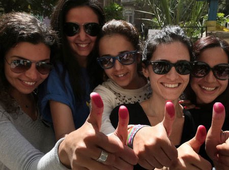 2018-02-23 Egyptian women with ink stained fingers after voting in post-revolution elections
